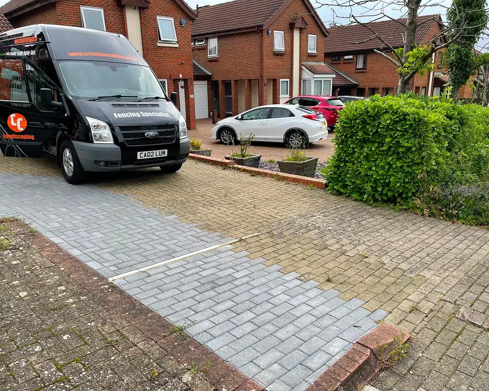 Driveway paving with a black fencing contractor van parked outside a house