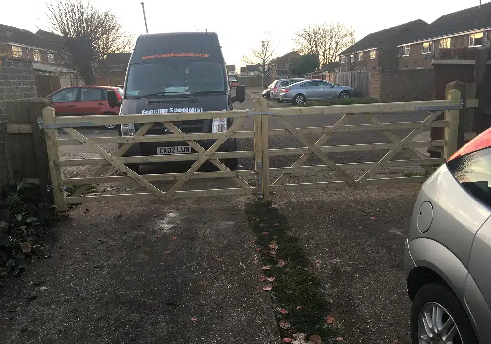 Wooden driveway gate with a van parked behind it in a residential street